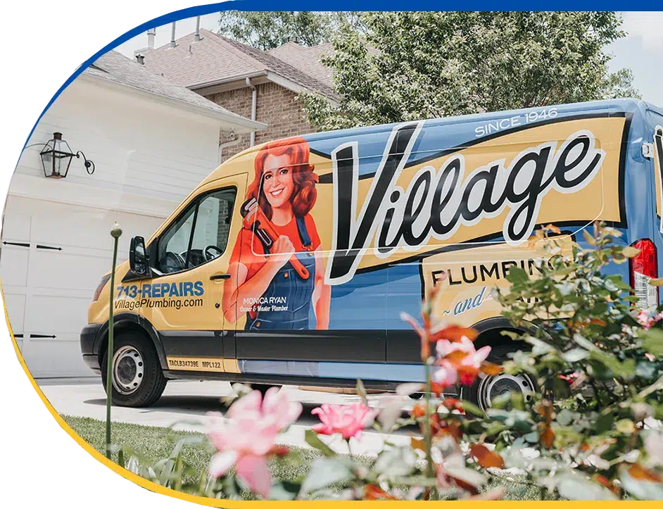 Village Plumbing, Air, & Electric service van parked in front of a home's white garage, with flowers in foreground.